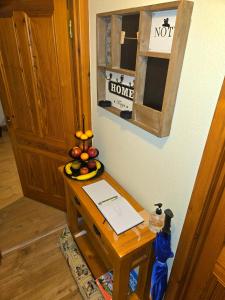 a table with a bowl of fruit on top of it at Luichart Lodge in Lochluichart Station +7 photos