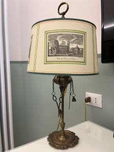 a lamp on a table with a picture of a train at UNYCA - Domus22 - San Giovanni in Florence