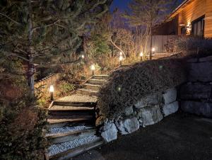 a set of stairs with lights at night at Le Ptit Beccon in Cruseilles