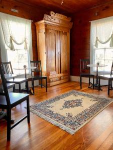 a living room with tables and chairs and a rug at Pennoli Bed and Breakfast in Gatesville