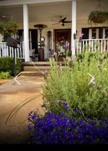 a house with a bunch of flowers in front of it at Pennoli Bed and Breakfast in Gatesville