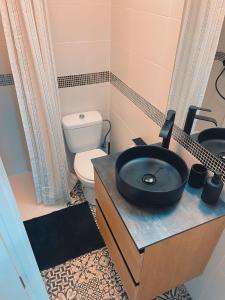 a bathroom with a sink and a toilet at A piece of paradise in Puerto de la Cruz in Puerto de la Cruz