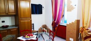 a kitchen with a table with a bowl of fruit on it at Moon House in Armento