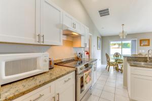 a kitchen with white cabinets and a sink at Pet-Friendly Palm Coast Home 8 Mi to Beach! in Palm Coast
