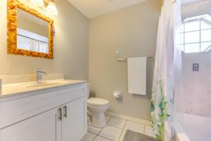 a bathroom with a sink and a toilet and a mirror at Pet-Friendly Palm Coast Home 8 Mi to Beach! in Palm Coast +23 photos