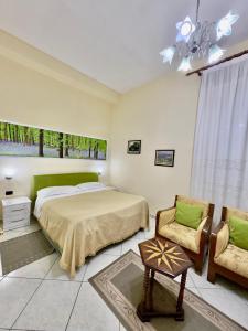 una camera da letto con un letto e una sedia di Hotel Kaduku a Shkodër