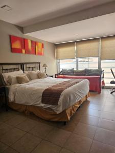 a bedroom with two beds and a large window at Apart Santa Marta in Salta +38 photos