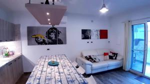 a living room with a table and a couch at P I -G Ó 's HOUSE in Budoni