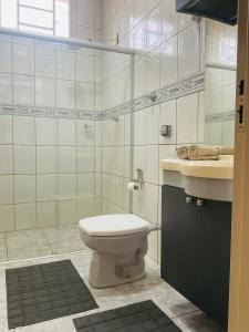 a bathroom with a toilet and a sink at Suite Delfinopolis in Delfinópolis