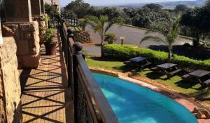a view of a swimming pool from a balcony at Ocean View Villas F10 in Port Edward