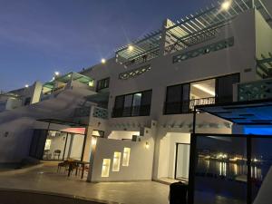 a large white building with a patio in front of it at شالية فندقي في شاطي البرادايس للعائلات in Durat  Alarous