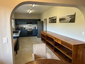 a kitchen with a wooden counter in a room at Dungbeetle Views in Wilderness