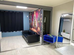 a living room with a couch and a painting on the wall at 스테이 휴가 의정부점 in Uijeongbu