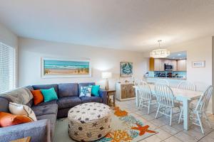 a living room with a couch and a table and chairs at Tar Landing Villas 306 in Atlantic Beach