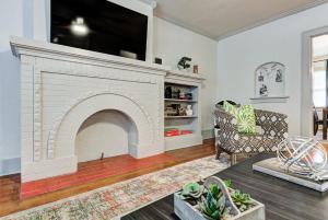 a living room with a white brick fireplace at Lincoln Lodge A near OU Med Bricktown Arena in Oklahoma City