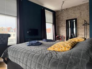 Postel nebo postele na pokoji v ubytování Stadslogement Hoogend