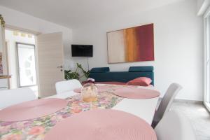 a dining room with a table and chairs at Apartments Flowers - Heated Pool Near Beach in Krk