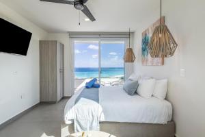a bedroom with a bed with a view of the ocean at Azulea Isla Mujeres Hotel in Isla Mujeres