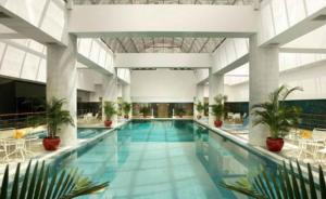 a large swimming pool in a large building at Ningbo Portman Plaza Hotel in Ningbo
