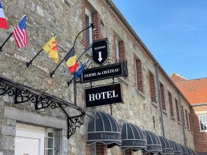 a hotel sign on the side of a building at La Ferme du Château - Luxury Suite in Fontaine-lʼÉvêque