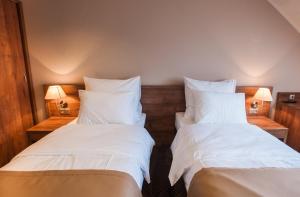 Łóżko lub łóżka w pokoju w obiekcie Hotel Gem