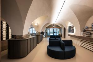 a salon with arched ceilings and chairs in a room at Posthotel Lamm in Vipiteno +140 photos