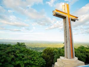 a large orthodox cross on top of a hill at Ketsys Home Near Santo Cerro in Concepción de La Vega