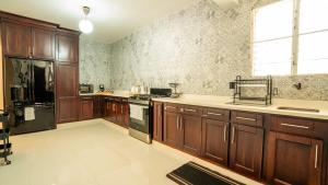 a large kitchen with wooden cabinets and a window at Ketsys Home Near Santo Cerro in Concepción de La Vega