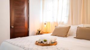 a white bed with a tray of towels on it at Ketsys Home Near Santo Cerro in Concepción de La Vega +28 photos