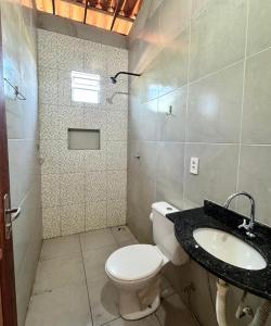 a bathroom with a toilet and a sink at Casadijaina in Amontada +7 photos