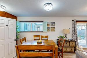 a dining room with a wooden table and chairs at Rockaway Beach Villa in Rockaway Beach +32 photos
