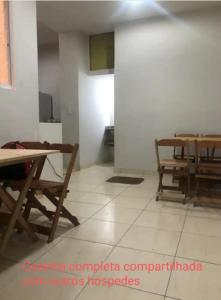 a dining room with tables and chairs in a room at Suíte 204 - Pousada no Centro do Rio in Rio de Janeiro +4 photos