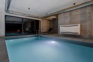 a swimming pool in a building with at A villa in Marija Trošt