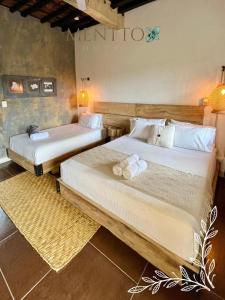 Voodi või voodid majutusasutuse Mentto Hotel toas
