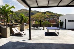 a patio with a table and chairs and a mountain at Norte Cali - Bosque Living -202 in Cali