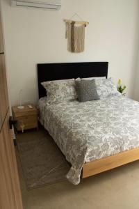 a bedroom with a bed and a nightstand next to it at Norte Cali - Bosque Living -202 in Cali
