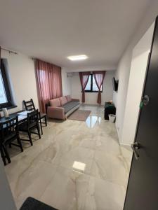 a living room with a couch and a table at Everest 33 Ap 4 in Bucharest