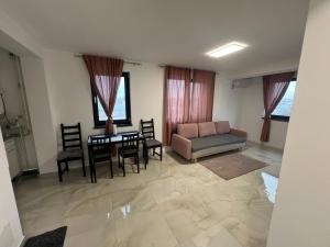a living room with a couch and a table and chairs at Everest 33 Ap 4 in Bucharest