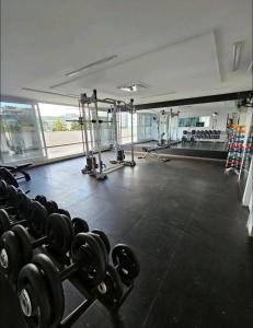 a gym with dumbbells in the middle of a room at Apartamento 2 Dormitórios, Bueno in Goiânia