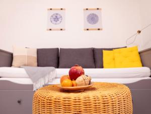 a bowl of fruit on a wicker table in a living room at Nice Weekends Graz City Centre - Free Parking, Pets Welcome & Walk to Old Town - Mur - Kunsthaus in Graz