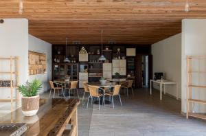 a room with tables and chairs in a room at In the countryside just 15 min from the airport and 5 min from train station in Stezzano