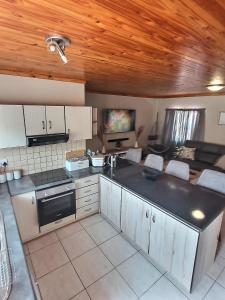 a kitchen with a black counter top in a room at Sea-Esta in Hentiesbaai