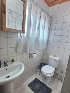 a white bathroom with a toilet and a sink at Sea-Esta in Hentiesbaai +11 photos