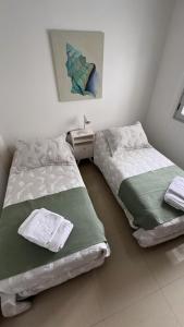 En eller flere senge i et værelse på Departamento Atlantic