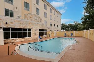 a large swimming pool in front of a building at Holiday Inn Express & Suites Houston Northwest-Brookhollow by IHG in Houston