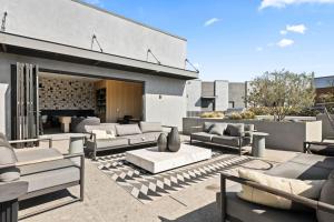 a living room with couches and chairs on a patio at 2BD Modern DTLA Apartment Minutes from Dodger Stadium in Los Angeles