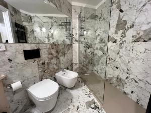 a bathroom with a toilet and a sink at Alpine glow - sophisticated ski in - ski out in Breuil-Cervinia