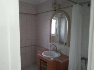 a bathroom with a sink and a mirror at Penthouse Peaceful Oasis in Lagonissi +40 photos
