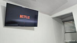 a television hanging on a wall in a room at Alojamiento campestre Barbosa Santander in Barbosa +9 photos