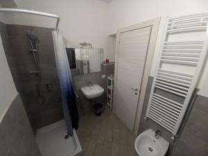 a bathroom with a sink and a shower and a toilet at Console Camprini Estates - Faenza Apartments 2 in Faenza